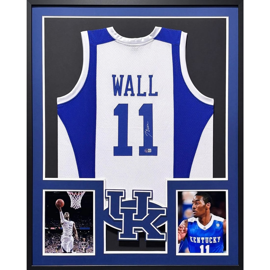 Framed Kentucky Blue White Jersey Signed by John Wall Beckett Authenticated: Framed Kentucky Blue White Jersey Signed by John Wall Beckett Authenticated Framed John Wall signed Kentucky jersey in blue and white. This pre-owned display piece features detailed framing and a logo