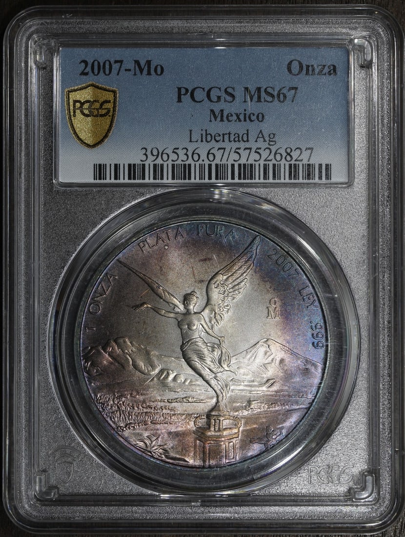 PCGS MS67 2007-Mo Mexico 1 oz Silver Libertad Onza Toned Coin: PCGS MS67 2007-Mo Mexico 1 oz Silver Libertad Onza Toned Coin 2007-Mo Mexico Silver Libertad Onza graded MS67 by PCGS. This pre-owned coin contains 1 oz of .999 fine silver and features colorful tonin