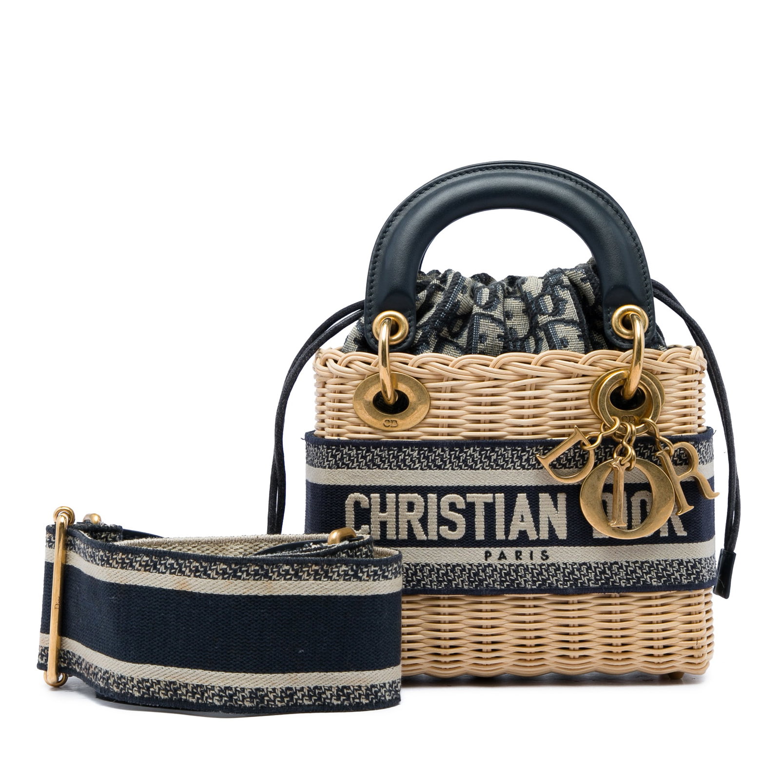 Dior Mini Lady Dior Wicker Handbag with Oblique Lining: Dior Mini Lady Dior Wicker Handbag with Oblique Lining A compact Dior mini bag crafted with a hand-woven wicker body and structured leather handles. The design features an oblique canvas lining, a dra