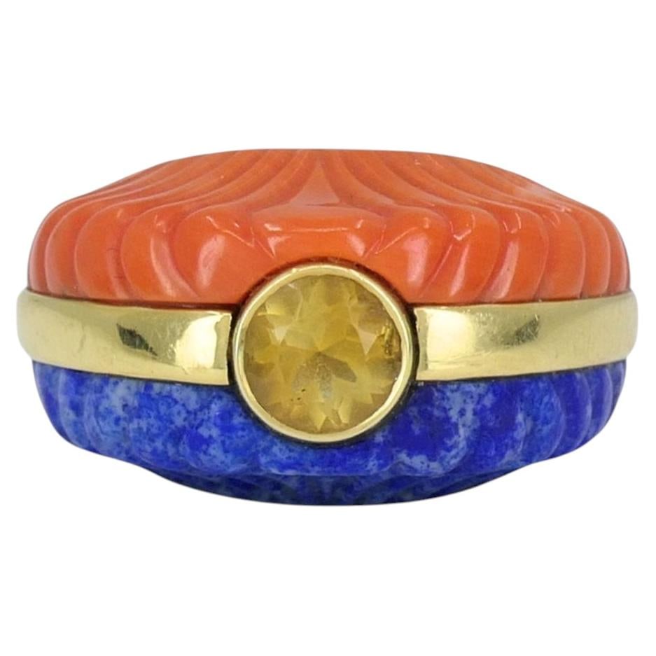 1970s 18k Yellow Gold Dome Ring with Coral Lapis and Citrine: 1970s 18k Yellow Gold Dome Ring with Coral Lapis and Citrine Vintage 1970s cocktail ring in 18k yellow gold with a bold domed design. The ring features carved coral and carved lapis lazuli panels on o