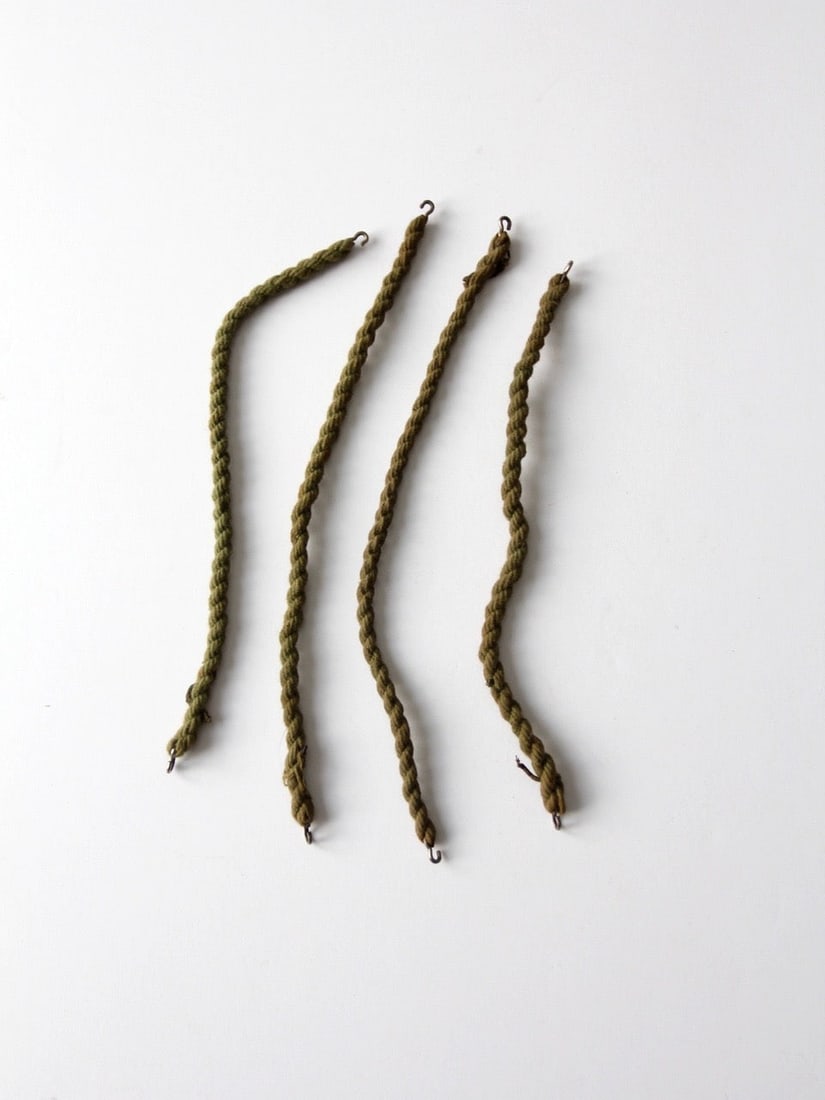 Set of 4 Vintage Military Boot Straps with Metal Hooks: Set of 4 Vintage Military Boot Straps with Metal Hooks Set of four vintage military boot blousing straps featuring tightly twisted olive drab cord and simple metal hook closures. These traditional uni