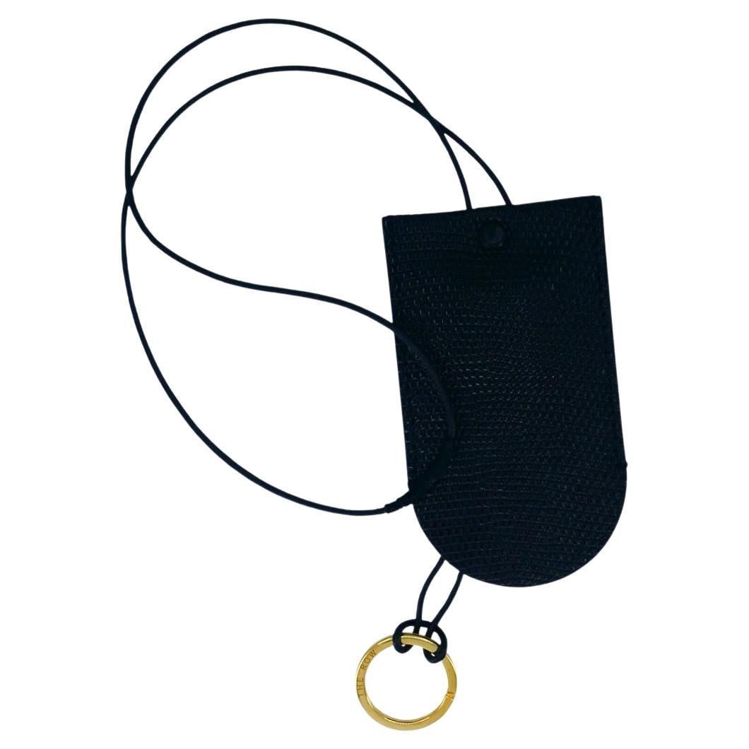 The Row Billy leather key ring gold tone with dust bag: The Row Billy leather key ring gold tone with dust bag The Row Billy key ring features a gold-tone keyring with a soft calfskin leather covering and a long neck cord. Made in Italy, it comes with a du
