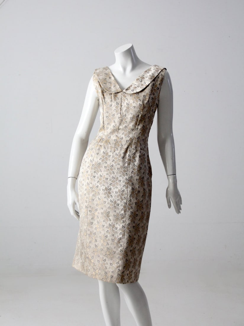 1960s Vintage Champagne Satin Brocade Dress with Floral Pattern: 1960s Vintage Champagne Satin Brocade Dress with Floral Pattern Step back in time with this exquisite 1960s vintage brocade dress. Crafted from luxurious champagne satin brocade, it features an elegan