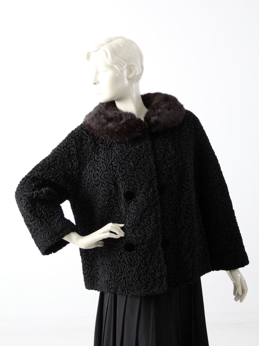 1950s Vintage Faux Persian Lamb Coat with Mink Collar: 1950s Vintage Faux Persian Lamb Coat with Mink Collar Step back in time with this exquisite 1950s vintage faux Persian lamb coat, designed for style and elegance. Crafted from soft black faux fur, thi