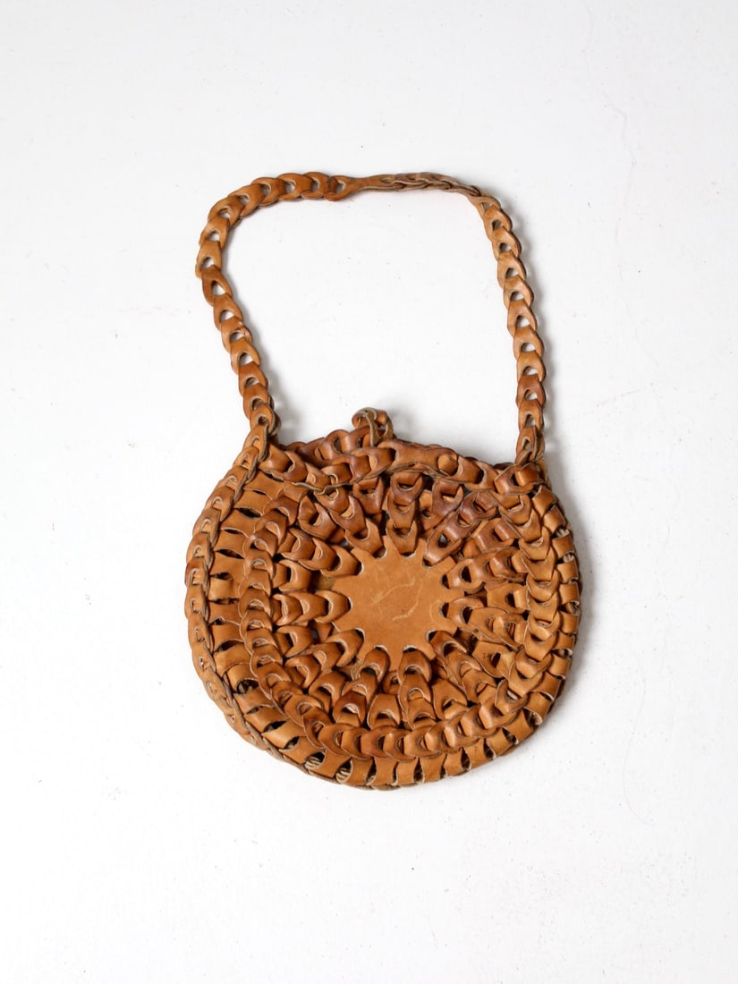 1970s Vintage Tan Leather Hippie Loop Bag: 1970s Vintage Tan Leather Hippie Loop Bag This vintage 1970s leather hippie loop bag features a distinctive round body crafted from tan leather, complemented by a single shoulder strap for easy carryi
