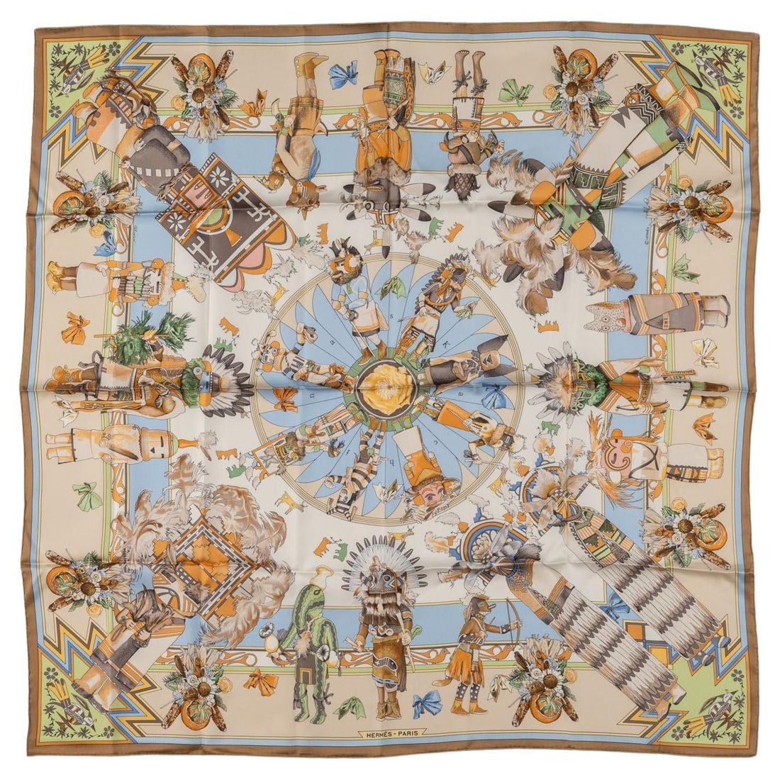 Hermes Kachinas 35 in silk scarf in beige: Hermes Kachinas 35 in silk scarf in beige Hermes "Kachinas" silk scarf featuring a bold multicolor motif. Crafted with hand-rolled edges, this piece comes without a box and is noted in excellent condi
