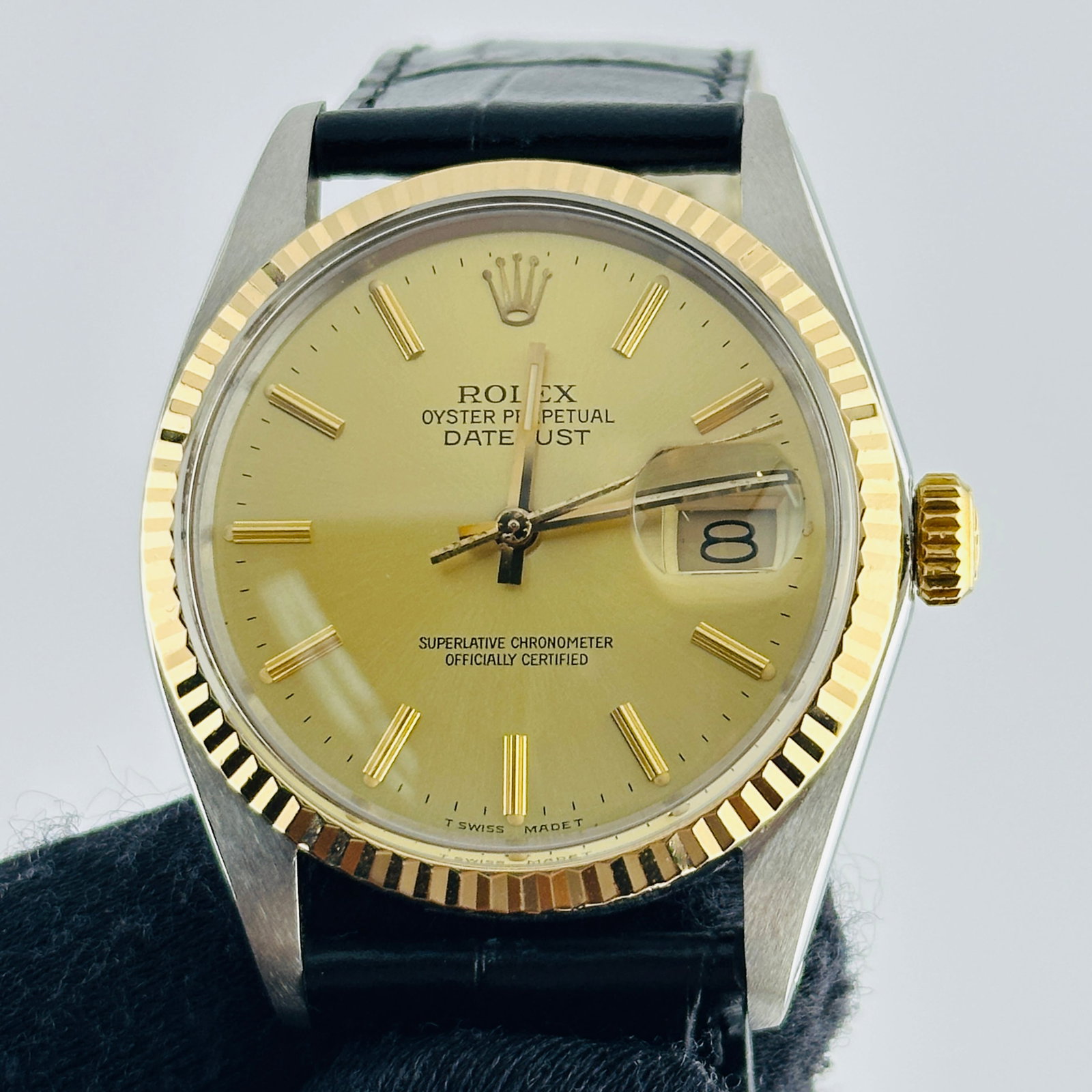 Rolex Datejust Ref. 16013 Mens Watch Champagne Dial Leather Strap: Rolex Datejust Ref. 16013 Mens Watch Champagne Dial Leather Strap Rolex Datejust reference 16013 with a champagne stick dial, fluted bezel, and generic leather band. This men's watch is presented in t