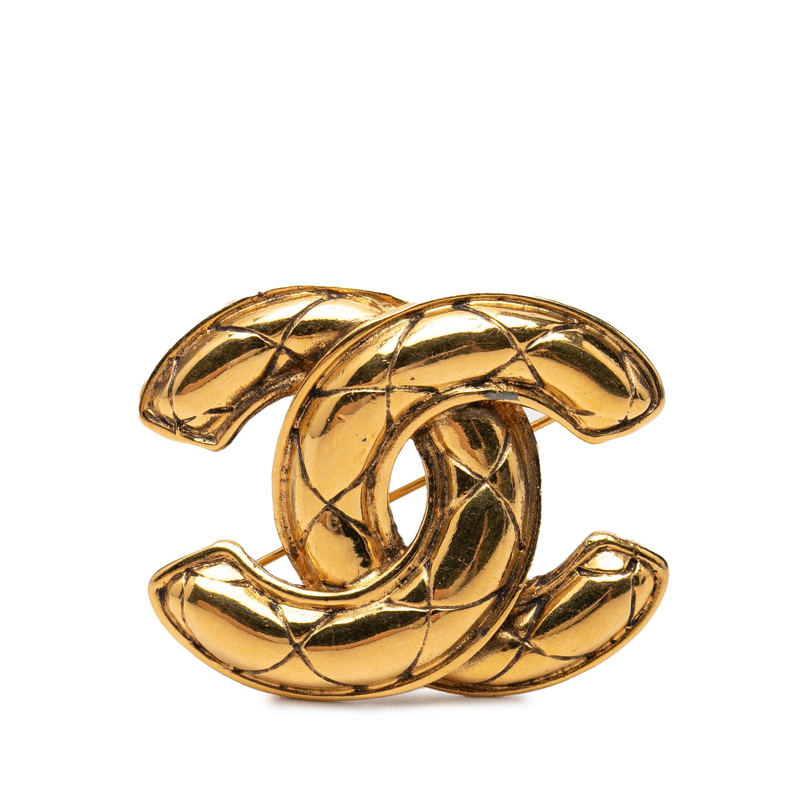 Chanel CC Quilted Gold Tone Metal Brooch: Chanel CC Quilted Gold Tone Metal Brooch Chanel CC quilted brooch in gold tone metal with a back pin closure. Made in France, this costume jewelry piece features the iconic CC motif. Condition is AB w