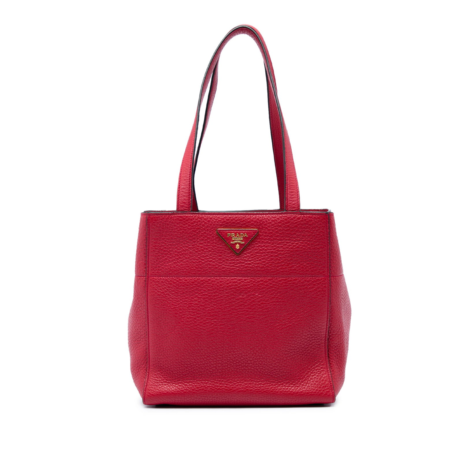 Prada Vitello Daino red leather tote bag: Prada Vitello Daino red leather tote bag Prada Vitello Daino tote bag crafted in red leather with flat leather straps, an open top, and a magnetic snap button closure. The interior includes zip and sl