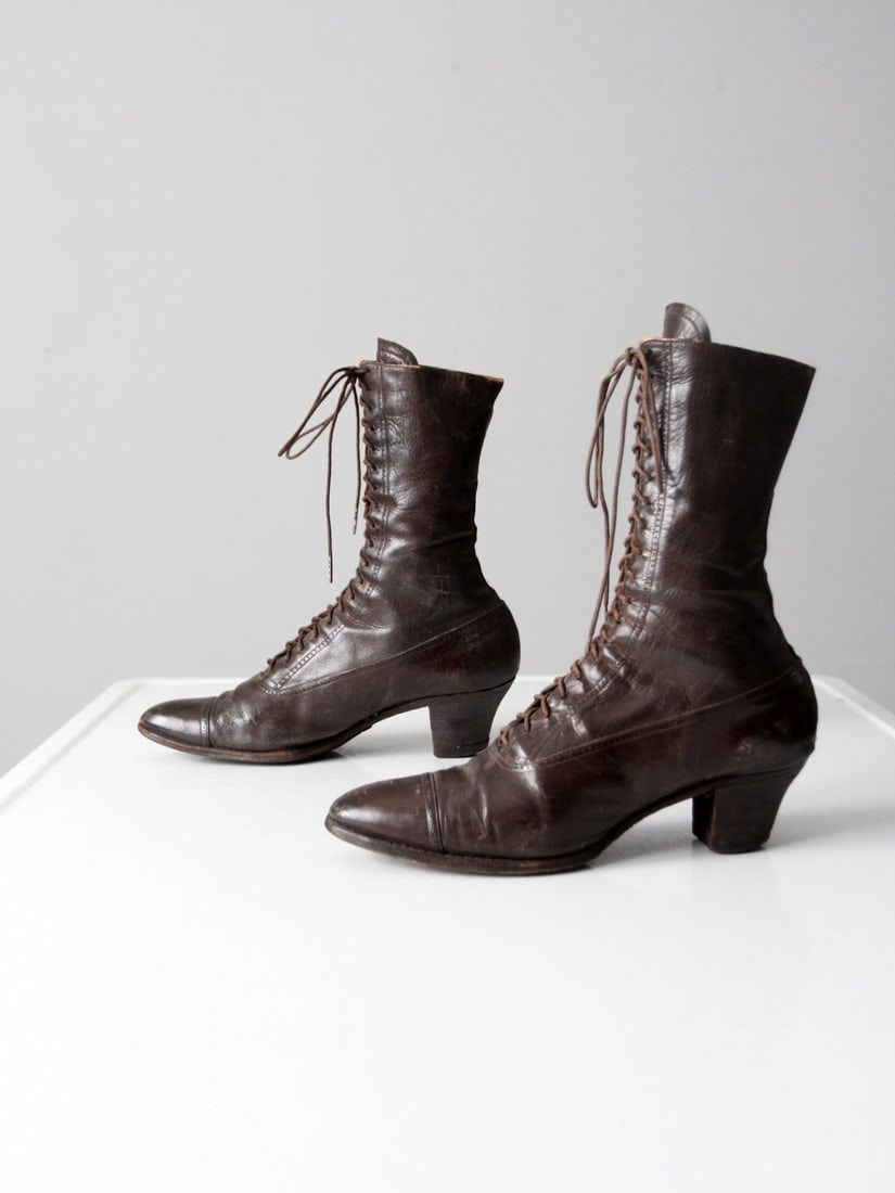 Pair of Brown Victorian Era Leather Lace-Up Boots Size 7: Pair of Brown Victorian Era Leather Lace-Up Boots Size 7 This pair of antique Victorian-era leather boots features a rich brown color, high wooden heels, pointed toes, and a lace-up front. The design 