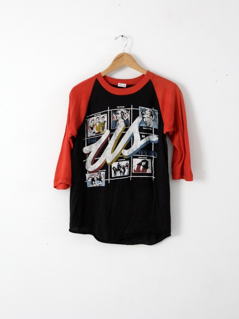 Vintage 1983 US Festival T-Shirt with Iconic Band Graphics: Vintage 1983 US Festival T-Shirt with Iconic Band Graphics This vintage t-shirt from the 1983 US Festival in San Bernardino, California, is a must-have for music lovers and collectors alike. Made from