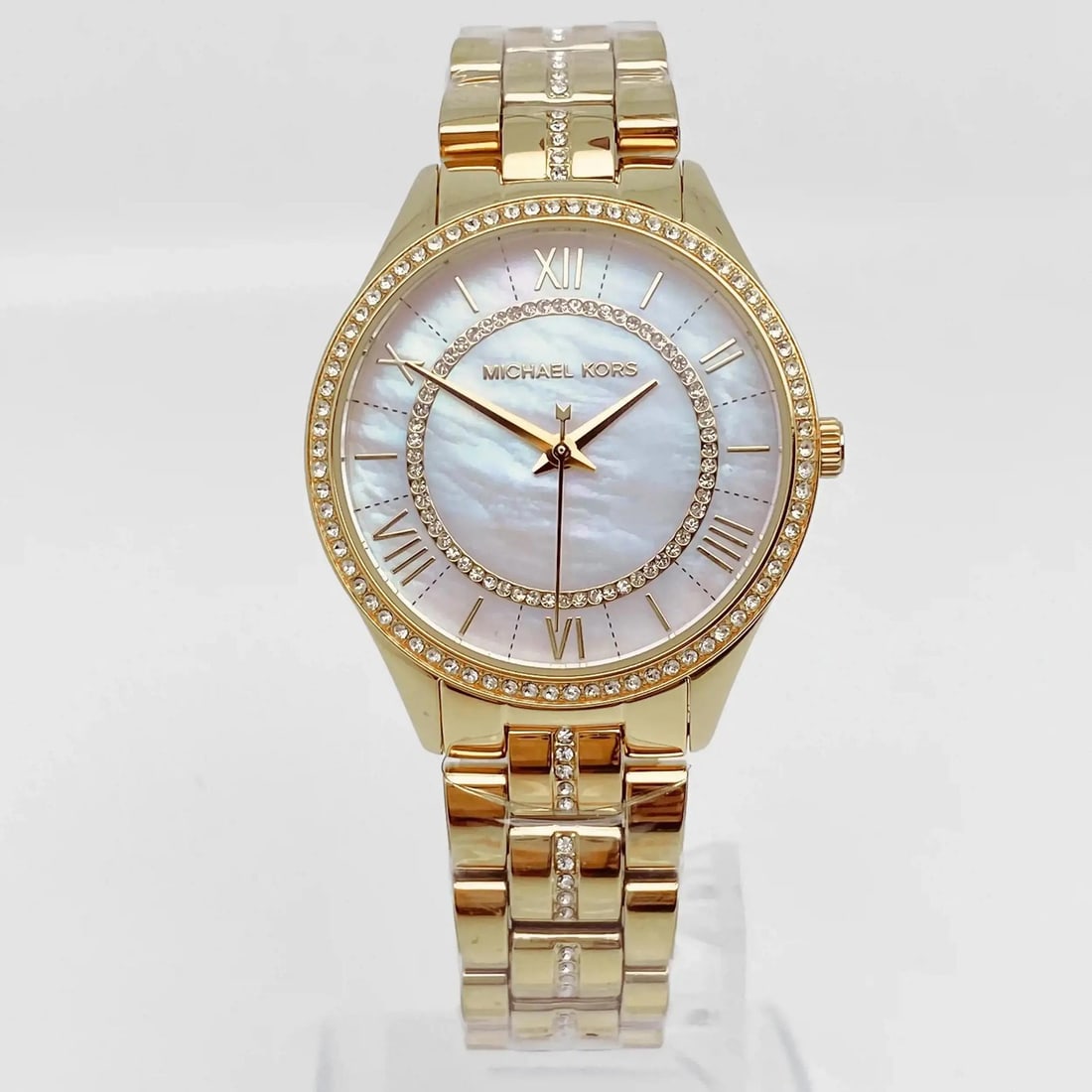 Michael Kors Lauryn womens 33mm bracelet watch MOP dial gold tone steel: Michael Kors Lauryn womens 33mm bracelet watch MOP dial gold tone steel Pre-owned Michael Kors Lauryn dress watch with a mother-of-pearl dial and gold-tone stainless steel bracelet. This analog quartz
