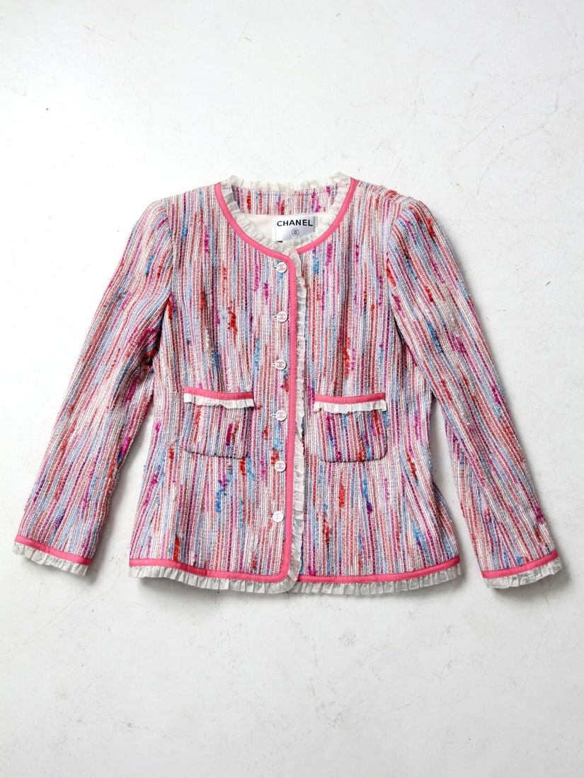 Colorful Vintage Chanel Tweed Jacket with Ruffle Details: Colorful Vintage Chanel Tweed Jacket with Ruffle Details This Vintage Chanel Jacket is a vibrant reinterpretation of the iconic Chanel tweed design, expertly crafted with luxurious materials including