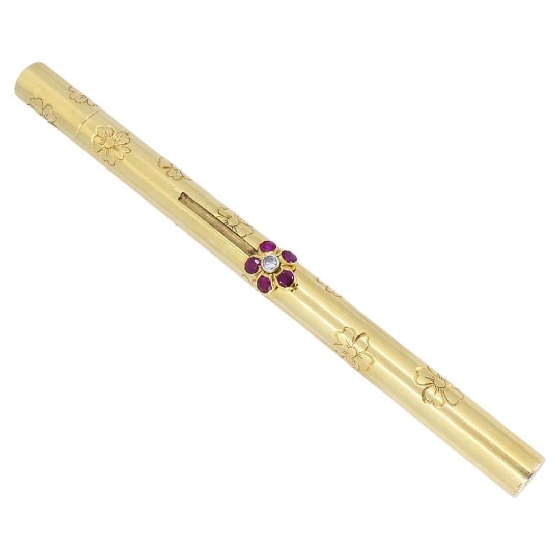 Van Cleef Arpels 14k Yellow Gold Ruby Retractable Makeup Brush Pendant: Van Cleef Arpels 14k Yellow Gold Ruby Retractable Makeup Brush Pendant An elegant retractable pocket make-up brush by Van Cleef & Arpels, crafted in 14k yellow gold with floral engravings and a round 