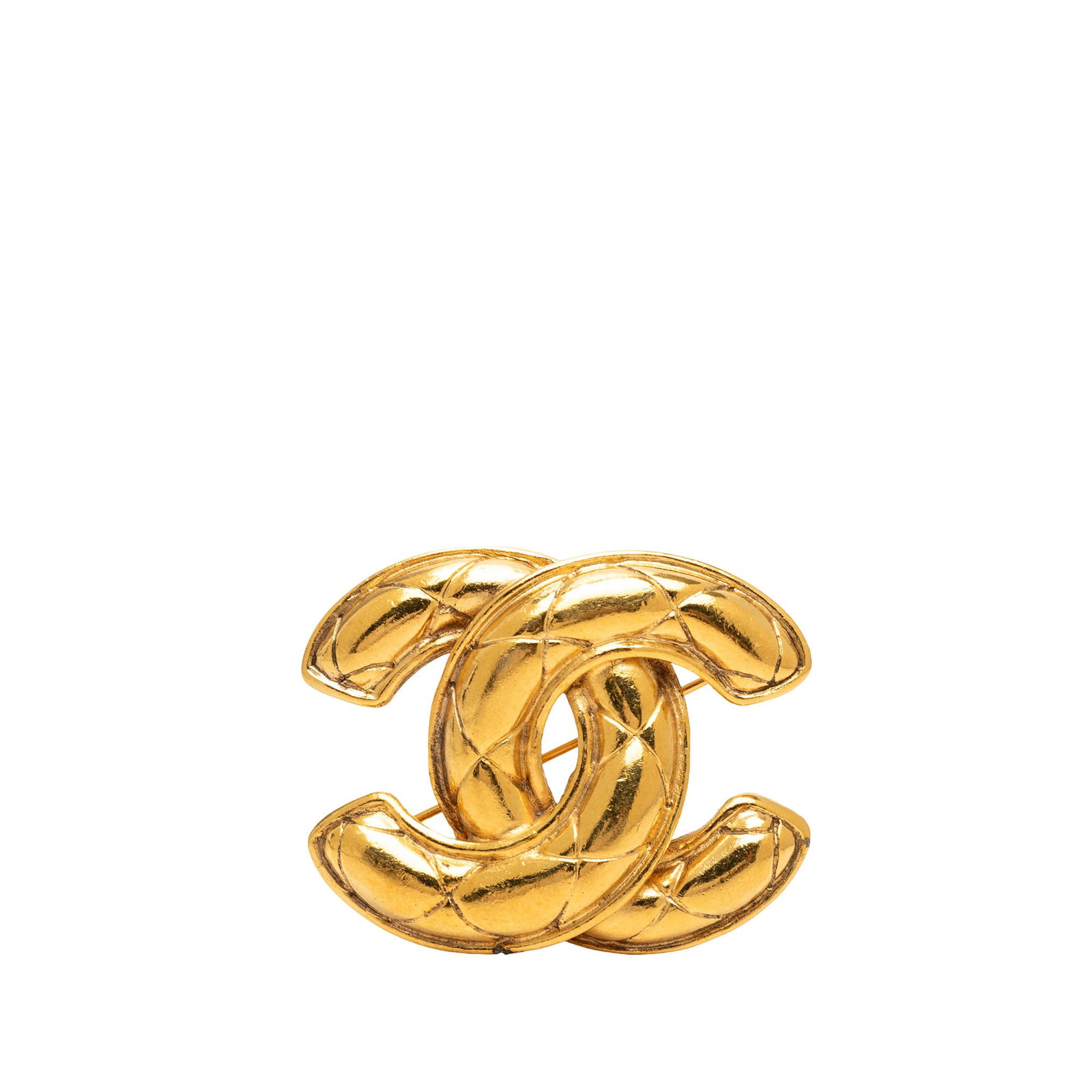 Chanel CC Quilted Gold Tone Metal Brooch: Chanel CC Quilted Gold Tone Metal Brooch A Chanel CC quilted brooch in gold tone metal with a back pin closure. This costume jewelry piece is made in France and shows scratched wear to the front, back