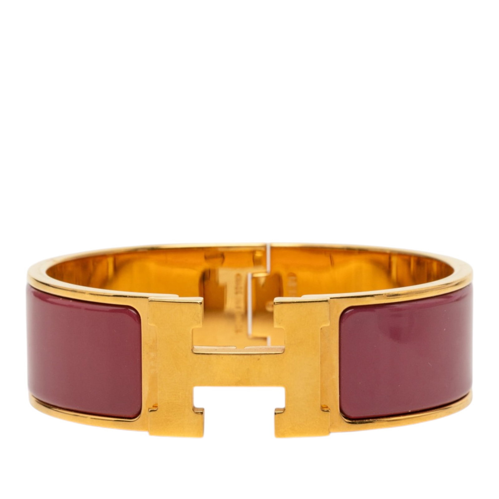 Hermes Clic Clac H PM wide enamel bracelet: Hermes Clic Clac H PM wide enamel bracelet Hermes Wide Enamel Clic Clac H Bracelet PM in red with a gold-plated metal body, enamel detailing, and a metal clasp closure. This costume bracelet is made i