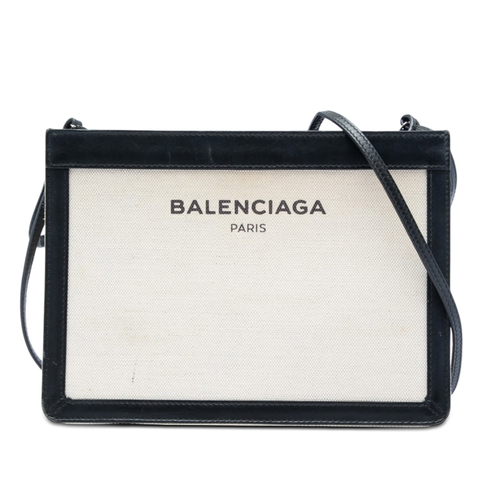 Balenciaga Navy Pochette Canvas Crossbody Bag with Leather Trim: Balenciaga Navy Pochette Canvas Crossbody Bag with Leather Trim Balenciaga Navy Pochette crossbody bag crafted with a canvas body and leather trim. It features an adjustable flat leather shoulder stra