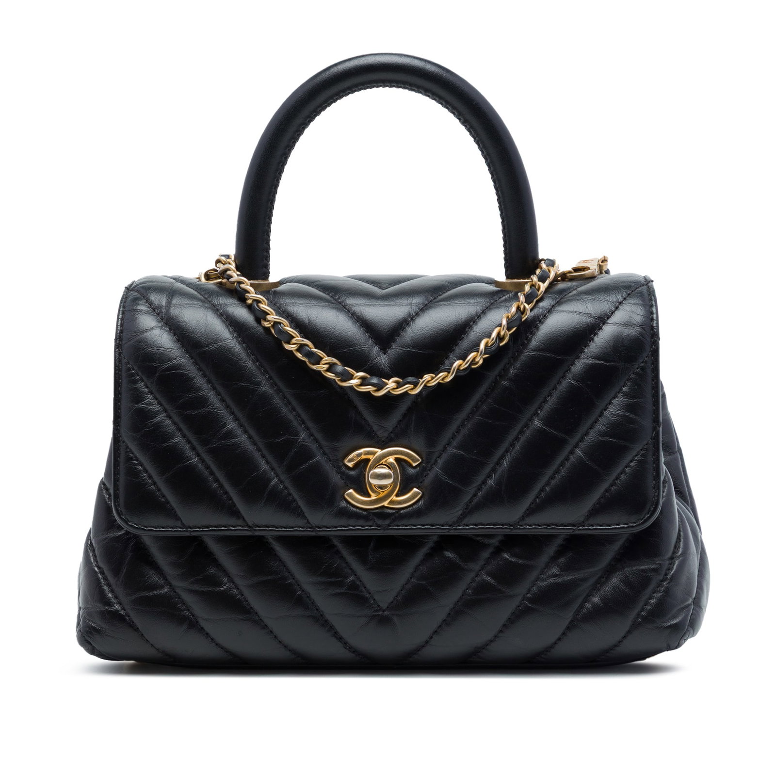Chanel Coco Top Handle Mini Bag in Black Aged Calfskin: Chanel Coco Top Handle Mini Bag in Black Aged Calfskin Compact and structured, this Chanel Mini Chevron Aged Calfskin Coco Top Handle Bag is crafted in black quilted leather with a rolled top handle a