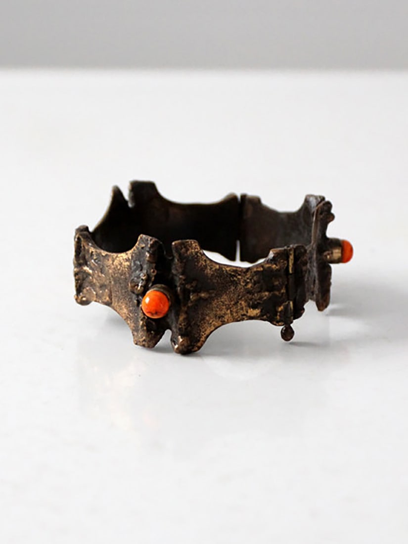 Sculptural 1970s Bronze Hinged Cuff Bracelet with Orange Cabochons: Sculptural 1970s Bronze Hinged Cuff Bracelet with Orange Cabochons Sculptural 1970s Brutalist cuff bracelet with an irregular architectural form and a heavily textured bronze-tone surface. This pre-ow