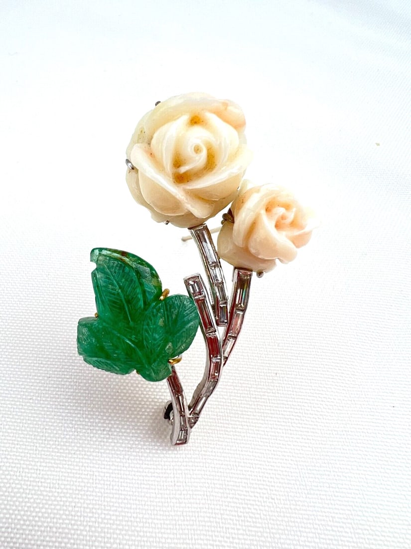 French 950 platinum brooch with emerald coral and diamonds: French 950 platinum brooch with emerald coral and diamonds French brooch crafted primarily in platinum with an emerald, coral, and diamond design. The back of the emerald is made of 18K yellow gold, a