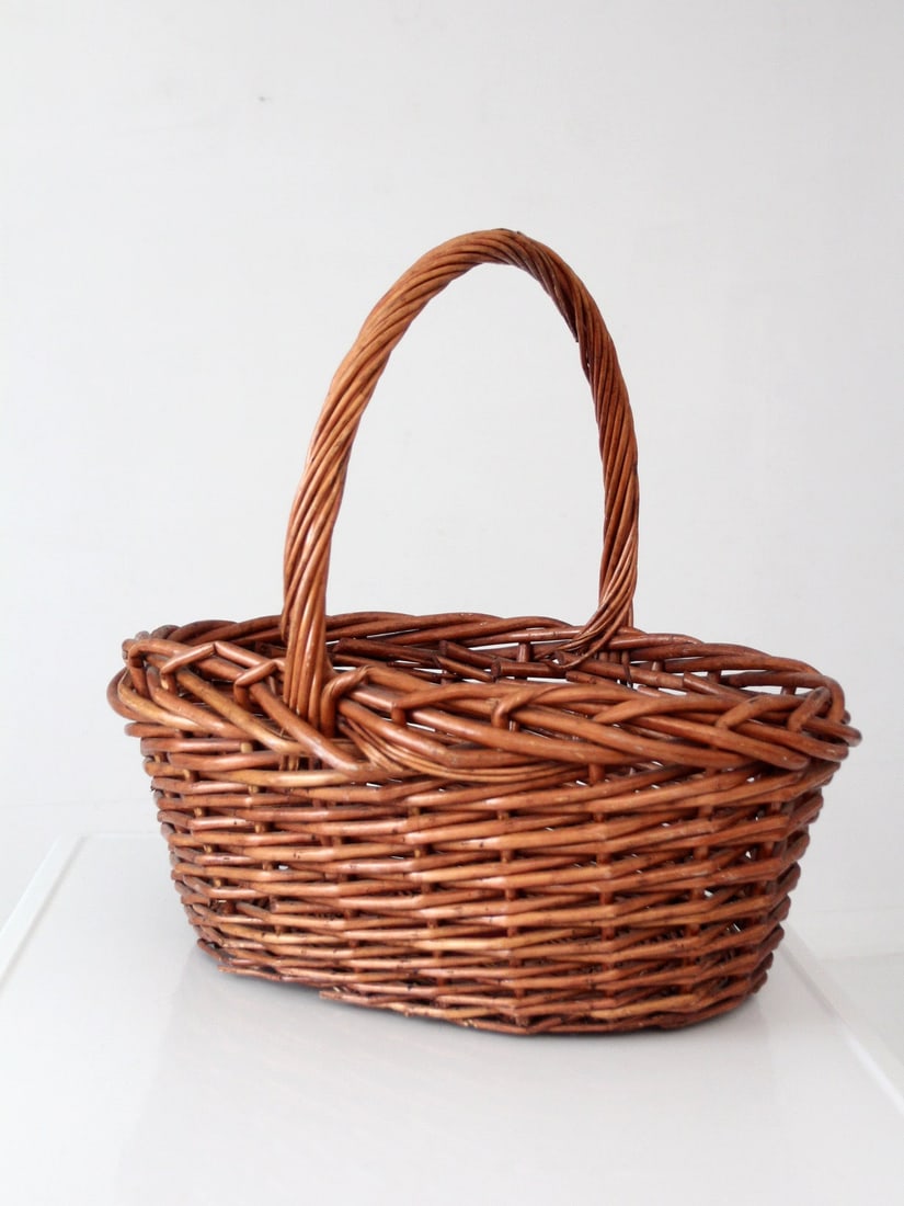 Handwoven Willow Harvest Basket with Tall Arched Handle 22 inch: Handwoven Willow Harvest Basket with Tall Arched Handle 22 inch Vintage large willow gathering basket with a handwoven form, tall arched handle, and oversized braided rim. The thick willow constructio