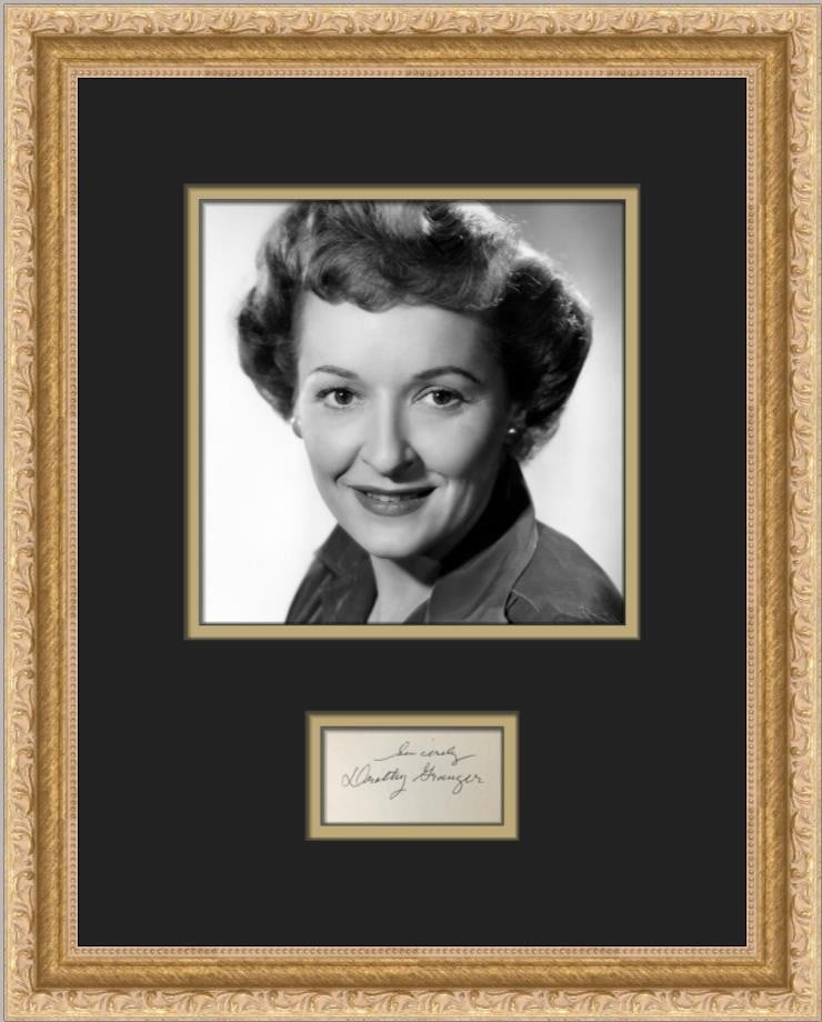 Custom Framed Dorothy Granger Autograph Cut with Portrait Photo: Custom Framed Dorothy Granger Autograph Cut with Portrait Photo Custom framed signed cut signature of Dorothy Granger, presented with a black-and-white portrait photograph. The display is professional