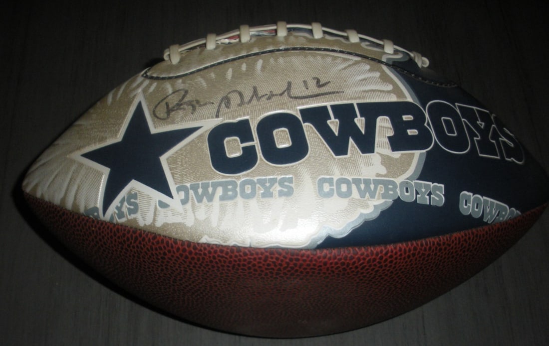 Signed Football with COA Honoring Roger Staubach Cowboys Navy HOF 1985: Signed Football with COA Honoring Roger Staubach Cowboys Navy HOF 1985 This is an original football signed by Roger Staubach, celebrated for his roles with the Dallas Cowboys and as a Navy Midshipman,
