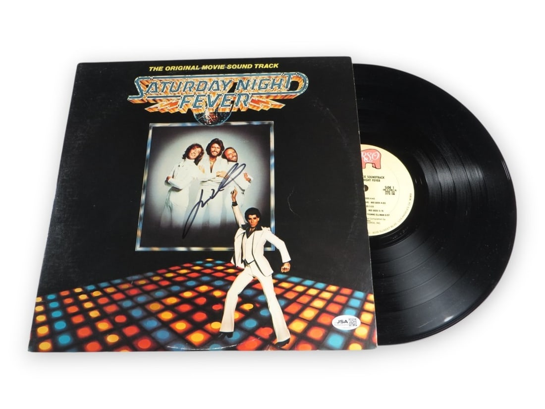Saturday Night Fever album cover signed by John Travolta JSA: Saturday Night Fever album cover signed by John Travolta JSA Original album cover autographed by John Travolta for Saturday Night Fever. This pre-owned piece has been authenticated by James Spence (JS