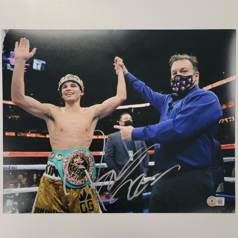 Signed 11x14 Ryan Garcia Boxing Photo with Beckett BAS Authentication: Signed 11x14 Ryan Garcia Boxing Photo with Beckett BAS Authentication This 11x14 photo features professional boxer Ryan Garcia and has been personally signed by him. The autograph is authenticated by 