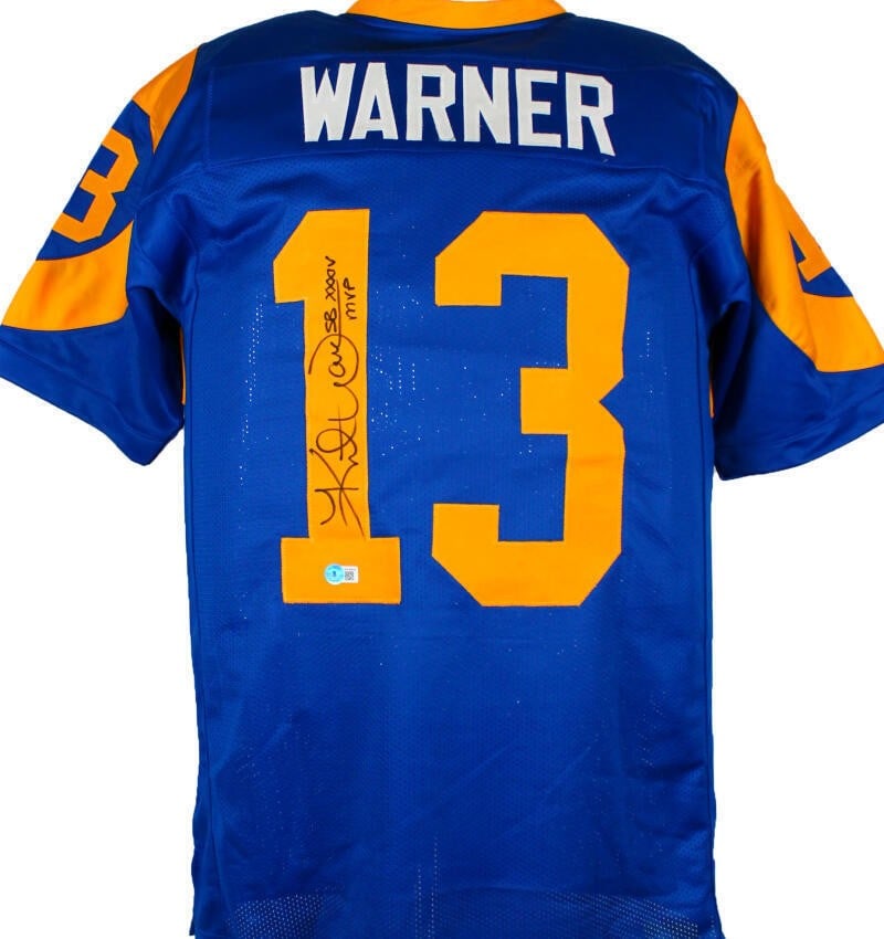 Kurt Warner Signed St. Louis Rams Pro Style Jersey Beckett Hologram: Kurt Warner Signed St. Louis Rams Pro Style Jersey Beckett Hologram Autographed blue and yellow pro style jersey featuring Kurt Warner. This pre-owned piece includes Beckett autograph authentication w
