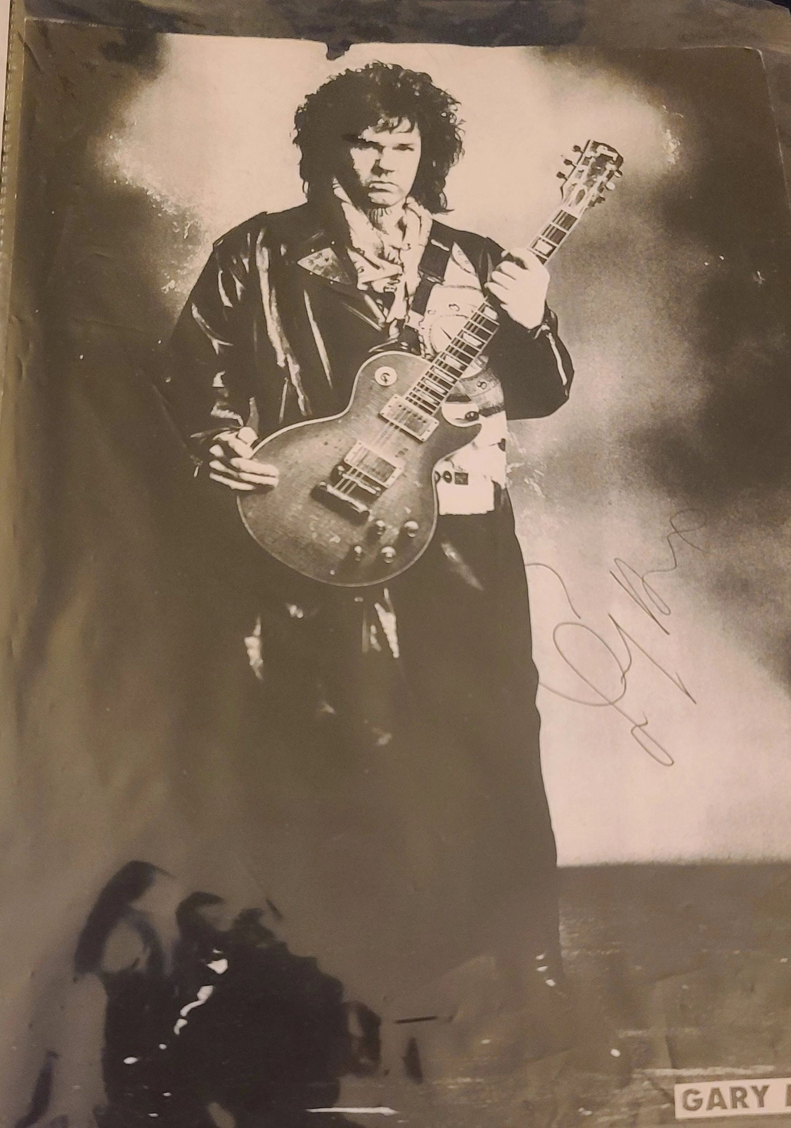 Autographed Gary Moore 10x11 Magazine Page Copy with Roger Epperson LOA: Autographed Gary Moore 10x11 Magazine Page Copy with Roger Epperson LOA Signed magazine page copy featuring guitarist Gary Moore. This autographed piece includes a Letter of Authenticity from Roger Ep