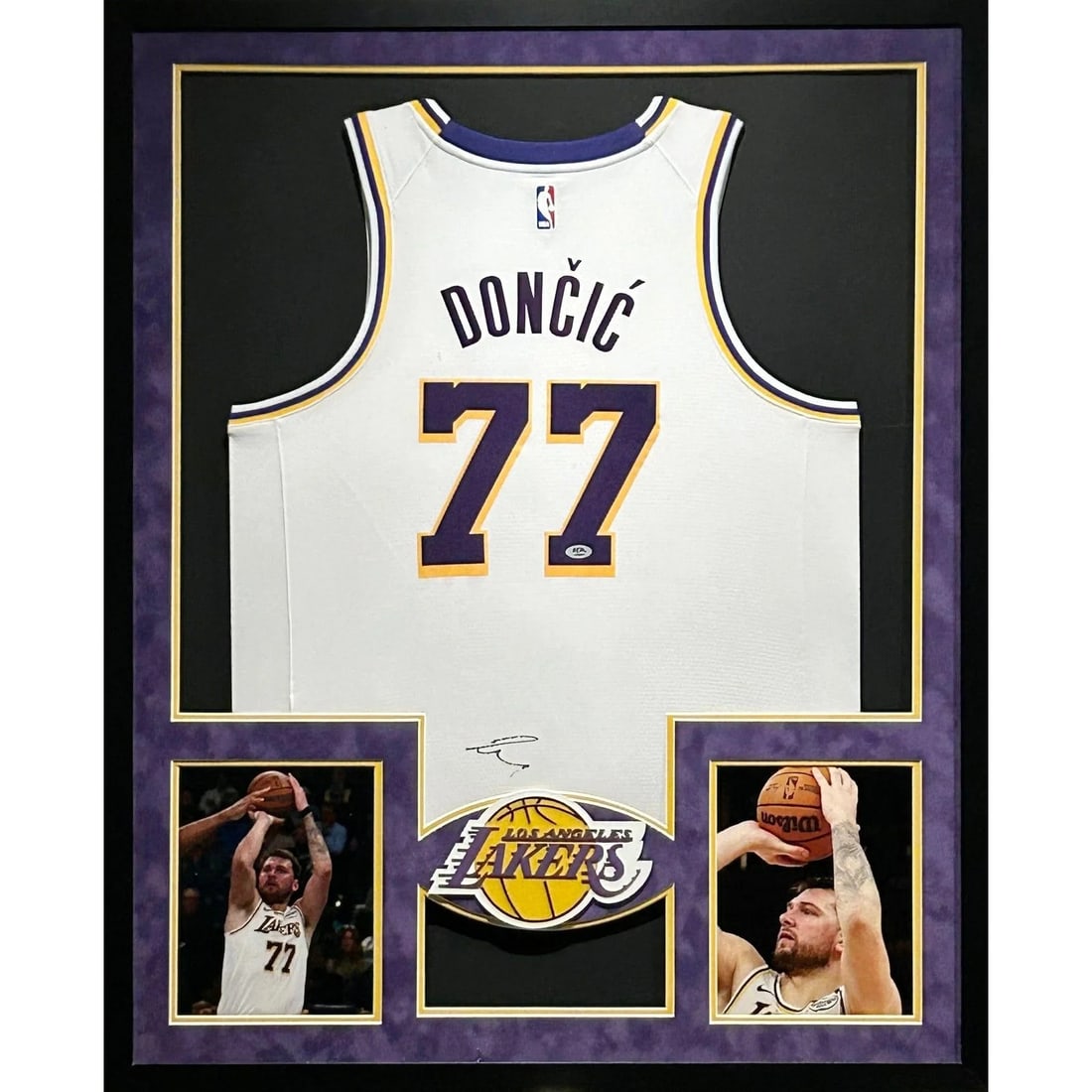 Framed Autographed Luka Doncic White Lakers Jersey PSA DNA: Framed Autographed Luka Doncic White Lakers Jersey PSA DNA Framed autographed white Luka Doncic jersey with PSA/DNA authentication. Presented in a detailed display frame with UV-protected acrylic, thi