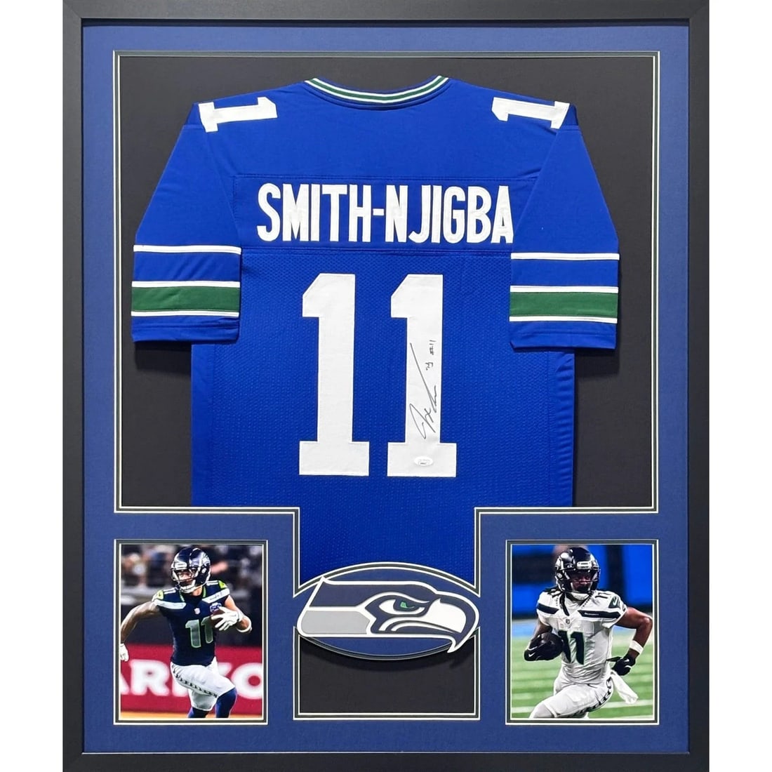 Framed Seattle Seahawks Jersey Signed by Jaxon Smith-Njigba JSA: Framed Seattle Seahawks Jersey Signed by Jaxon Smith-Njigba JSA Framed autographed Jaxon Smith-Njigba Seahawks jersey with JSA authentication. The piece features detailed framing with a team logo disp