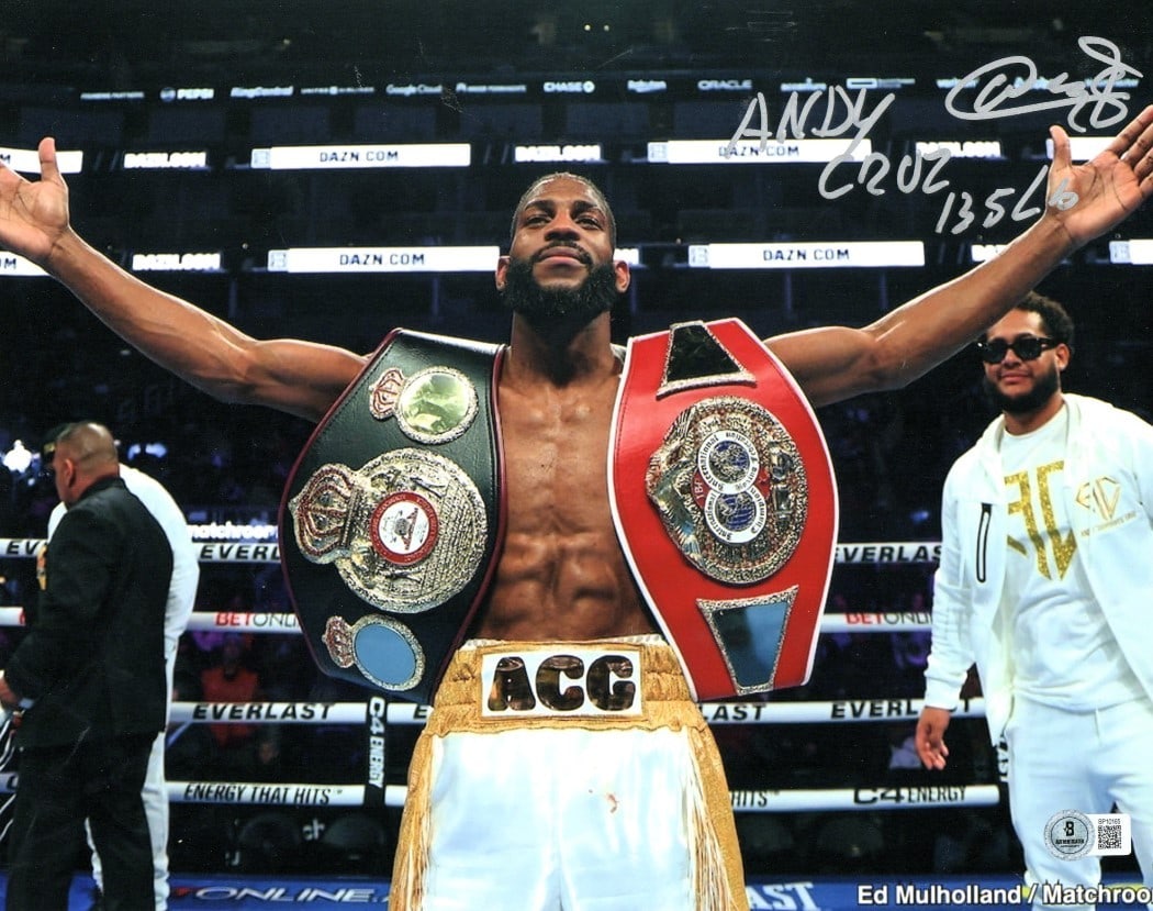 Andy Cruz autographed 11X14 boxing photo with two belts BAS: Andy Cruz autographed 11X14 boxing photo with two belts BAS Pre-owned original 11x14 boxing photo signed by Andy Cruz, featuring a two-belt image with "135 lbs" text. The autograph is authenticated by
