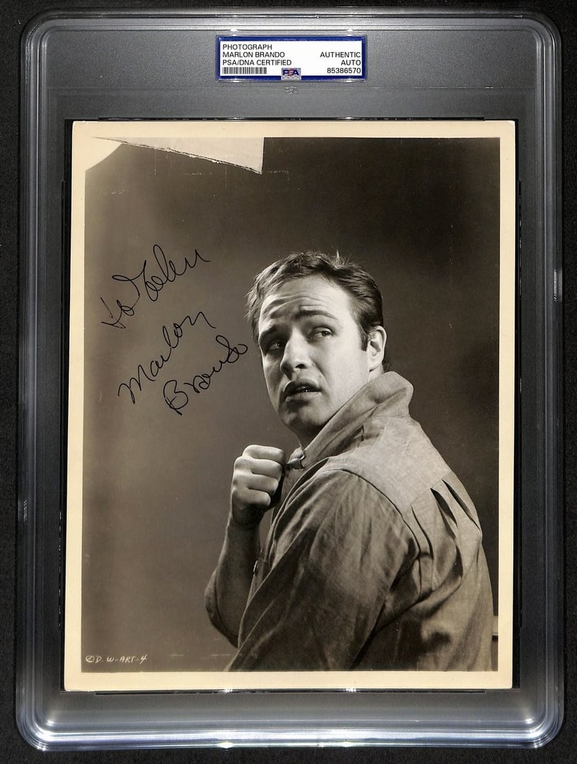 PSA DNA Autographed Marlon Brando 1954 On the Waterfront Promo Photograph: PSA DNA Autographed Marlon Brando 1954 On the Waterfront Promo Photograph Original 1954 studio-issued promotional photograph from On the Waterfront, signed by Marlon Brando in black ink with the inscr