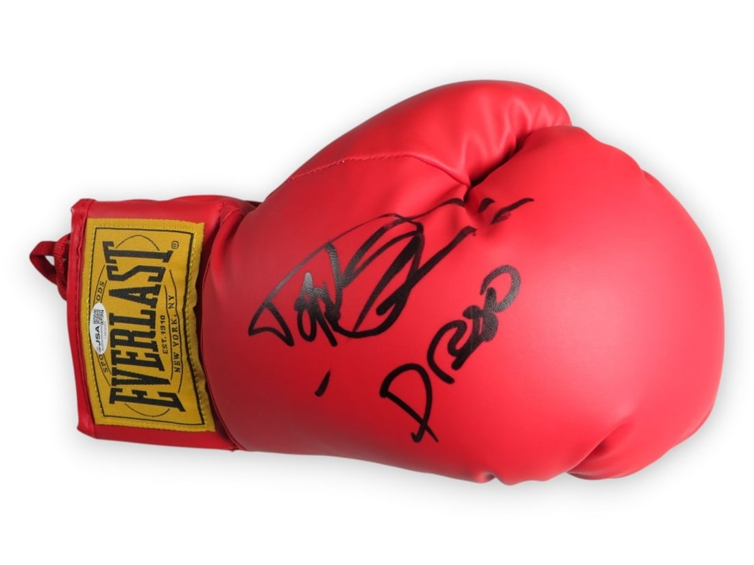 Dolph Lundgren autographed boxing glove Rocky IV Drago inscription JSA: Dolph Lundgren autographed boxing glove Rocky IV Drago inscription JSA Pre-owned boxing glove signed by Dolph Lundgren and inscribed with "Drago." This original autographed piece is authenticated by J