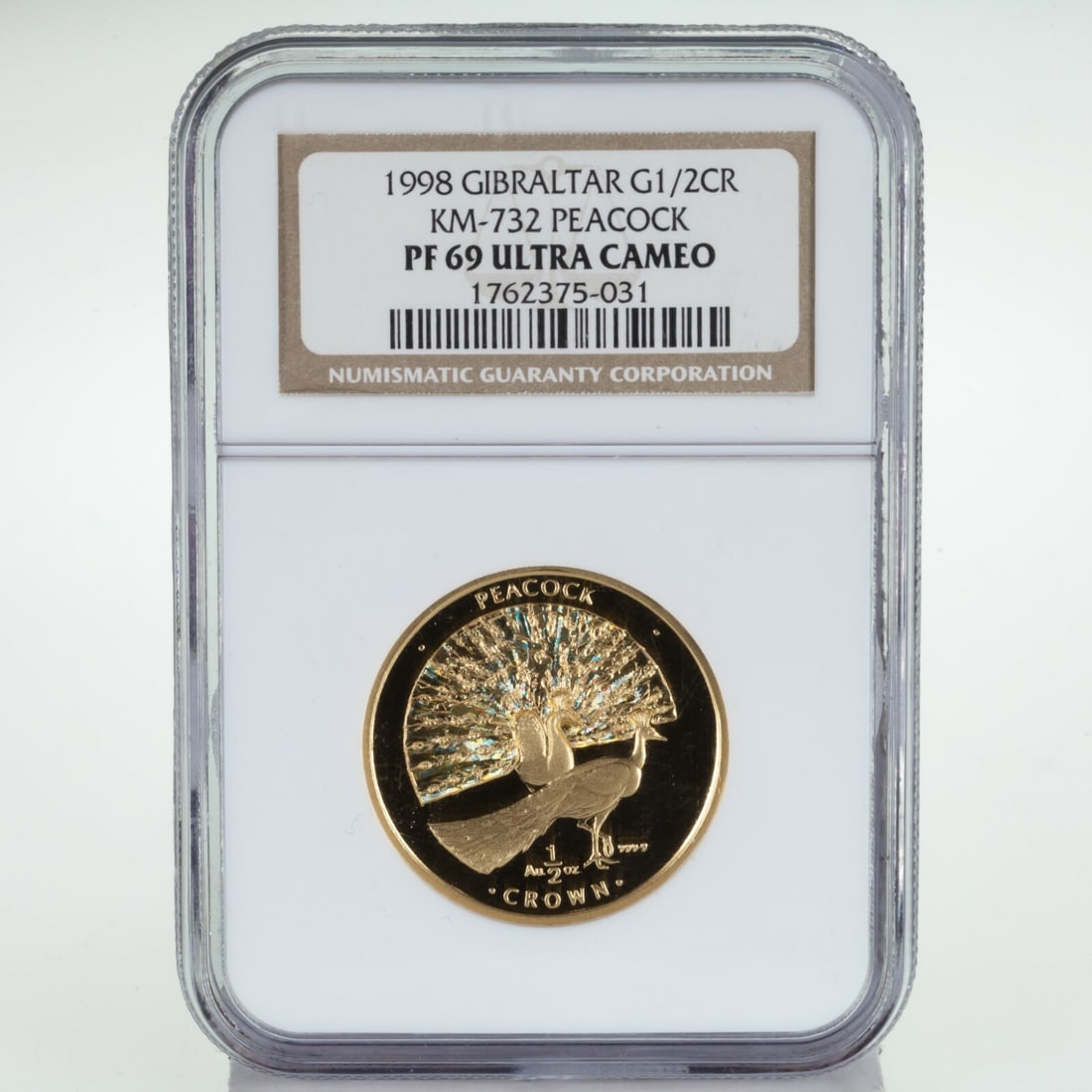 Gibraltar 1998 Gold 1/2 Crown Peacock NGC PF69 Ultra Cameo KM-732: Gibraltar 1998 Gold 1/2 Crown Peacock NGC PF69 Ultra Cameo KM-732 1998 Gibraltar 1/2 Crown Peacock gold proof coin with holographic detail, struck in .9999 fine gold and graded NGC PF69 Ultra Cameo. T