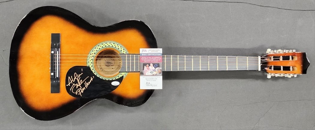 Acoustic Guitar Signed by Jake Shimabukuro with JSA Authentication: Acoustic Guitar Signed by Jake Shimabukuro with JSA Authentication This is an acoustic guitar hand signed by Jake Shimabukuro, the renowned ukulele virtuoso. The autograph has been authenticated by Ja