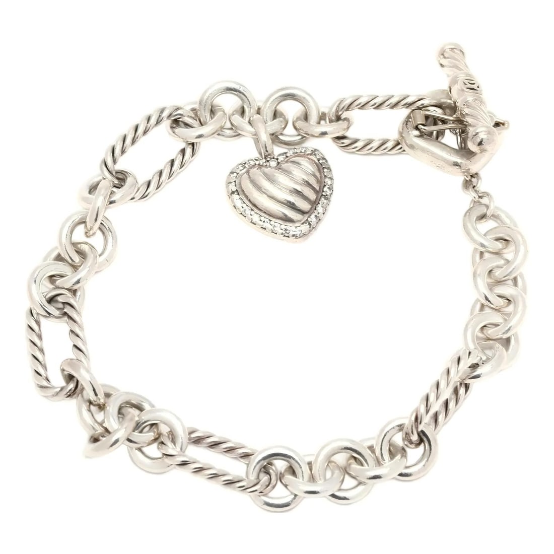 Sterling Silver Heart Charm Link Bracelet: STERLING SILVER HEART CHARM LINK BRACELET Description: The lot consists of a sterling silver link bracelet composed of alternating twisted rope-style and smooth circular links; the bracelet is fitted