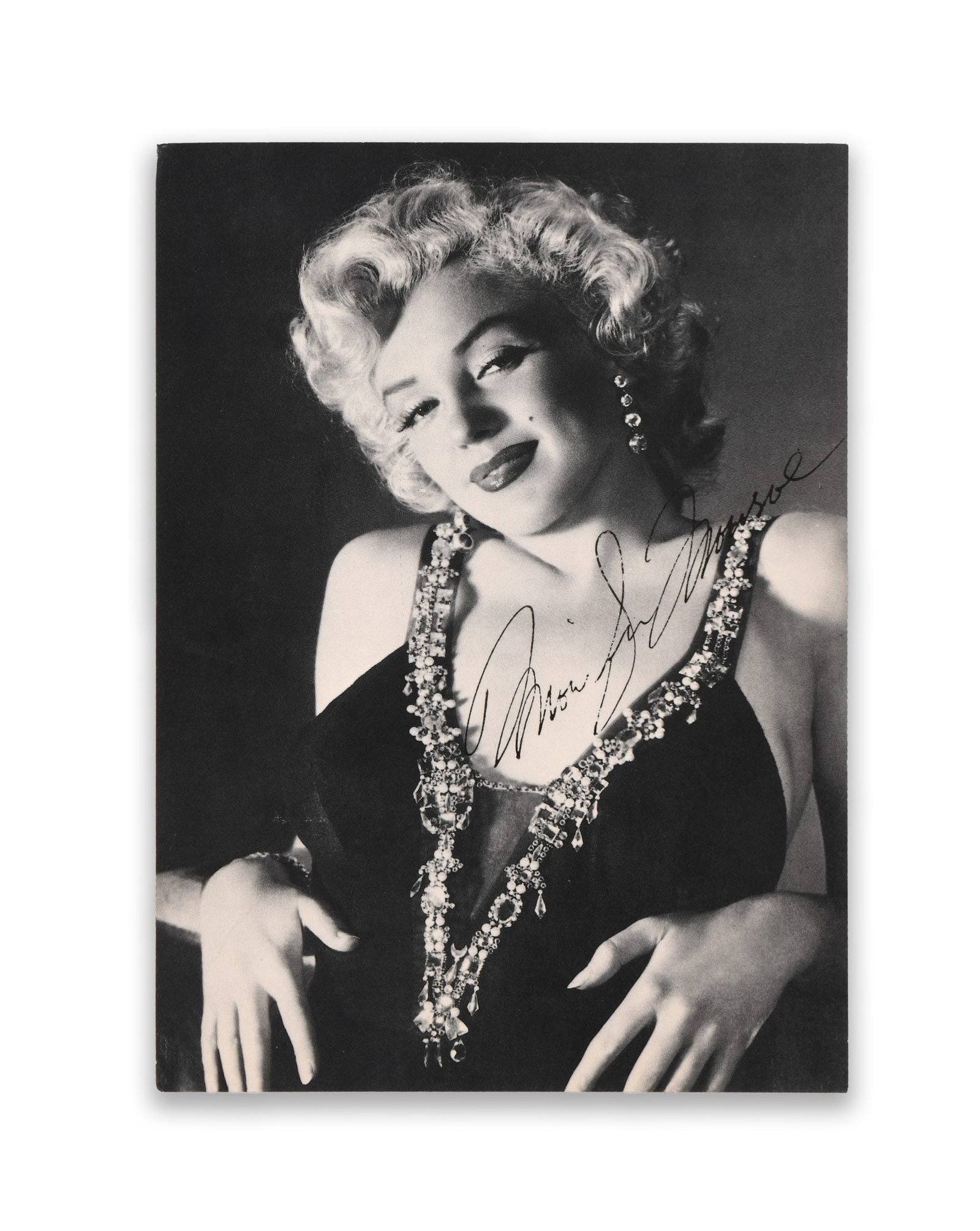 Marilyn Monroe (1926–1962), Signed Photograph Postcard, circa 1950s: MARILYN MONROE (1926–1962), SIGNED PHOTOGRAPH POSTCARD, CIRCA 1950SProvenance and Authenticity:This item includes a certificate of authenticity. This black-and-white glamour portrait of Marilyn