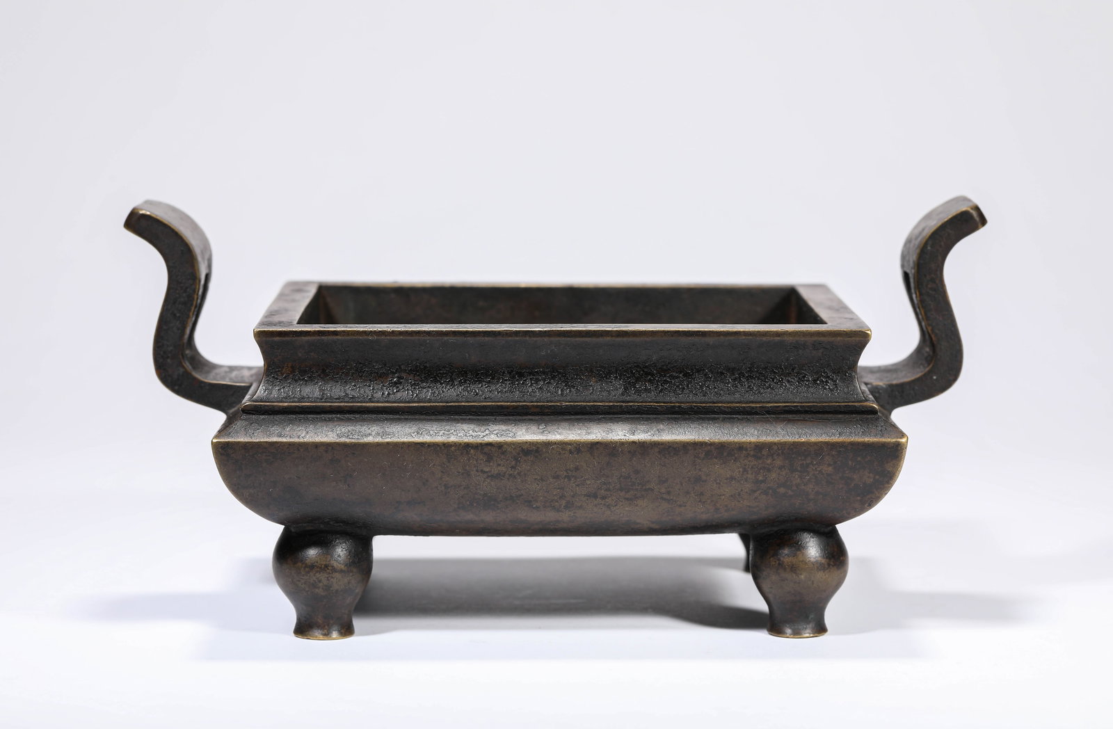 A Bronze ‘Court Hat Handles’ Censer: A BRONZE ‘COURT HAT HANDLES’ CENSER Description: Model: Made in the Jiajing Year of the Ming Dynasty (1522) Material: Copper Weight: 3692 g. Length: 24.1 cm x Width: 15 cm x Height: 11.5 cm. All m