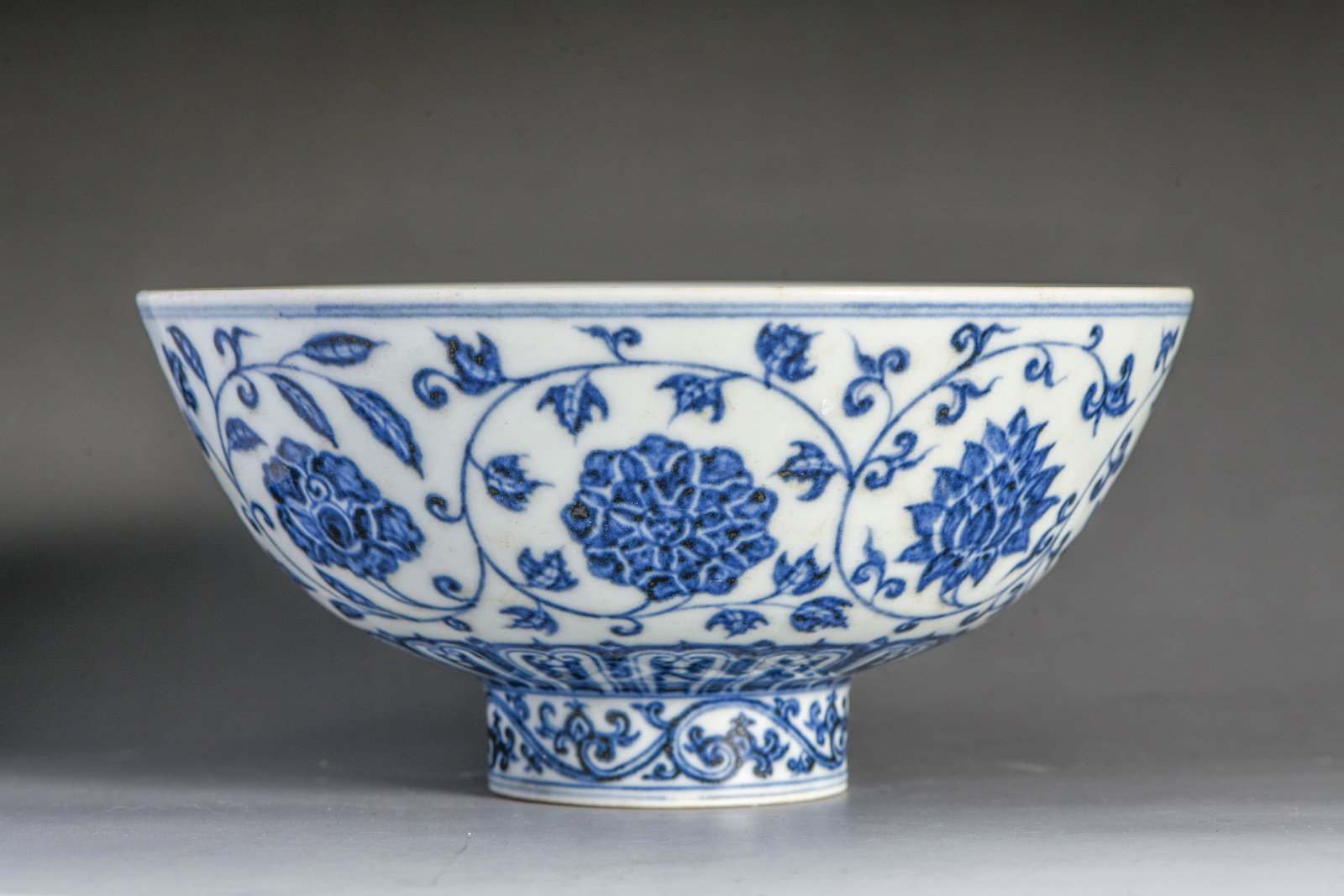 Blue and White Scroll-Decorated Floral Pattern Bowl: BLUE AND WHITE SCROLL-DECORATED FLORAL PATTERN BOWL Description: Item: Large Ming Dynasty Xuande Period Porcelain Width: 17.5 cm x Height: 8.5 cm