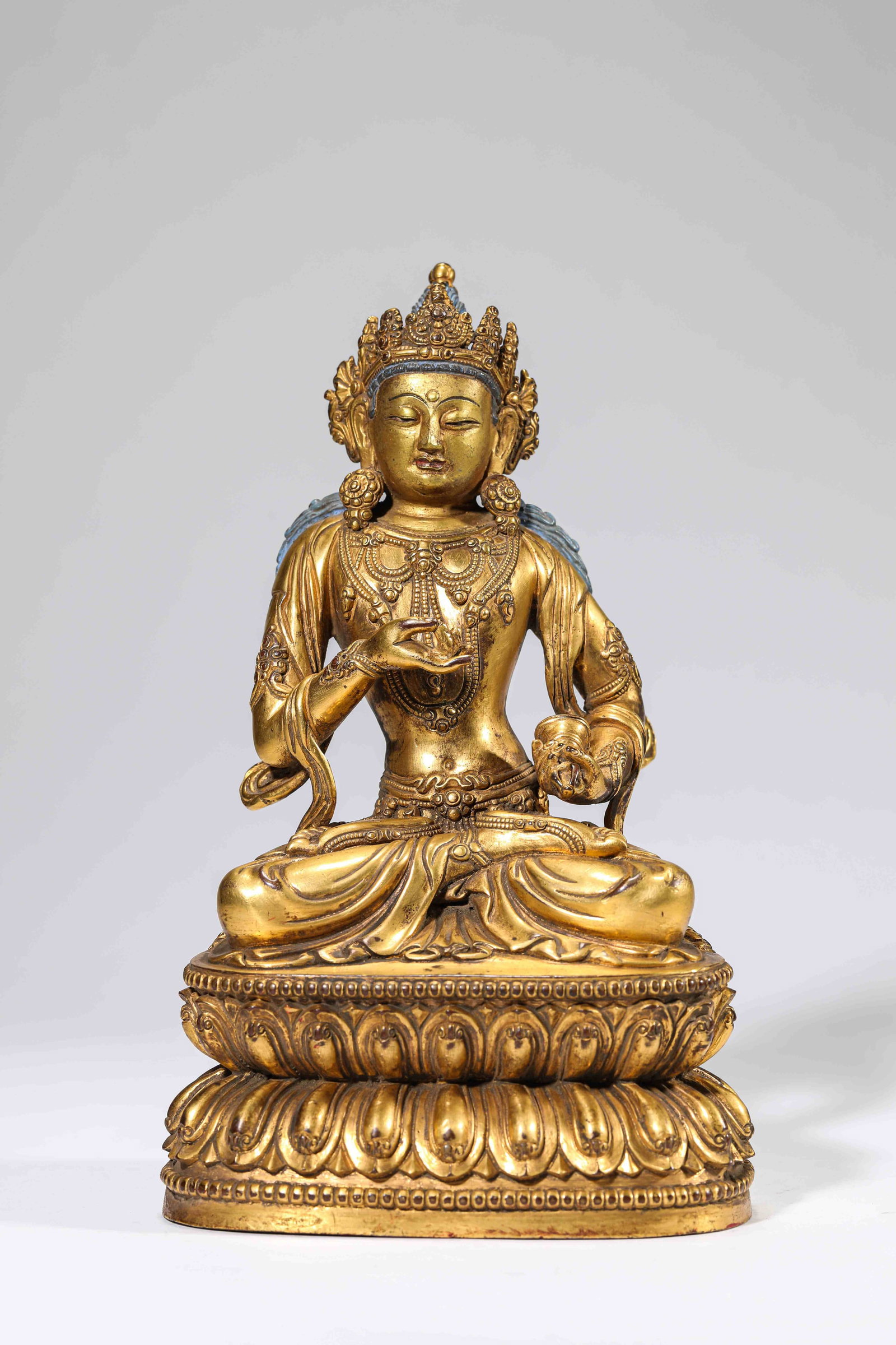 A Gilt-Bronze Figure of Buddha: A GILT-BRONZE FIGURE OF BUDDHA Dimensions: Dimensions: Weight: 2261 g. Length: 14 cm x Width: 9.5 cm x Height: 23 cm. All measurements are approximate.