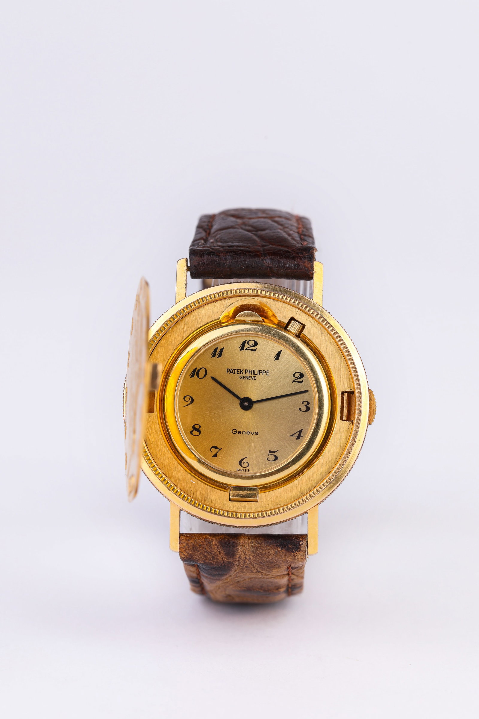 A Patek Philippe Gold Coin Watch: A PATEK PHILIPPE GOLD COIN WATCH Description: Dimensions: Width: 36 mm. All measurements are approximate.
