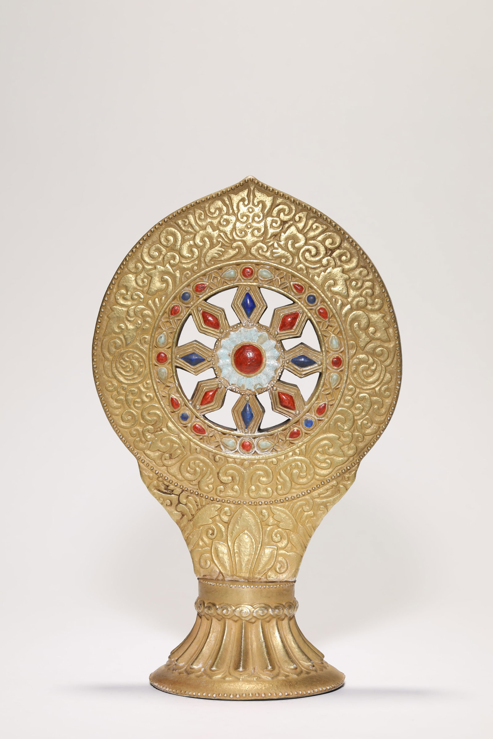 A 'Gold-Glazed Imitation' Dharma Wheel: A 'GOLD-GLAZED IMITATION' DHARMA WHEEL Description: Dimensions: Length: 17 cm x Width: 10.9 cm x Height: 27.5 cm. All measurements are approximate.