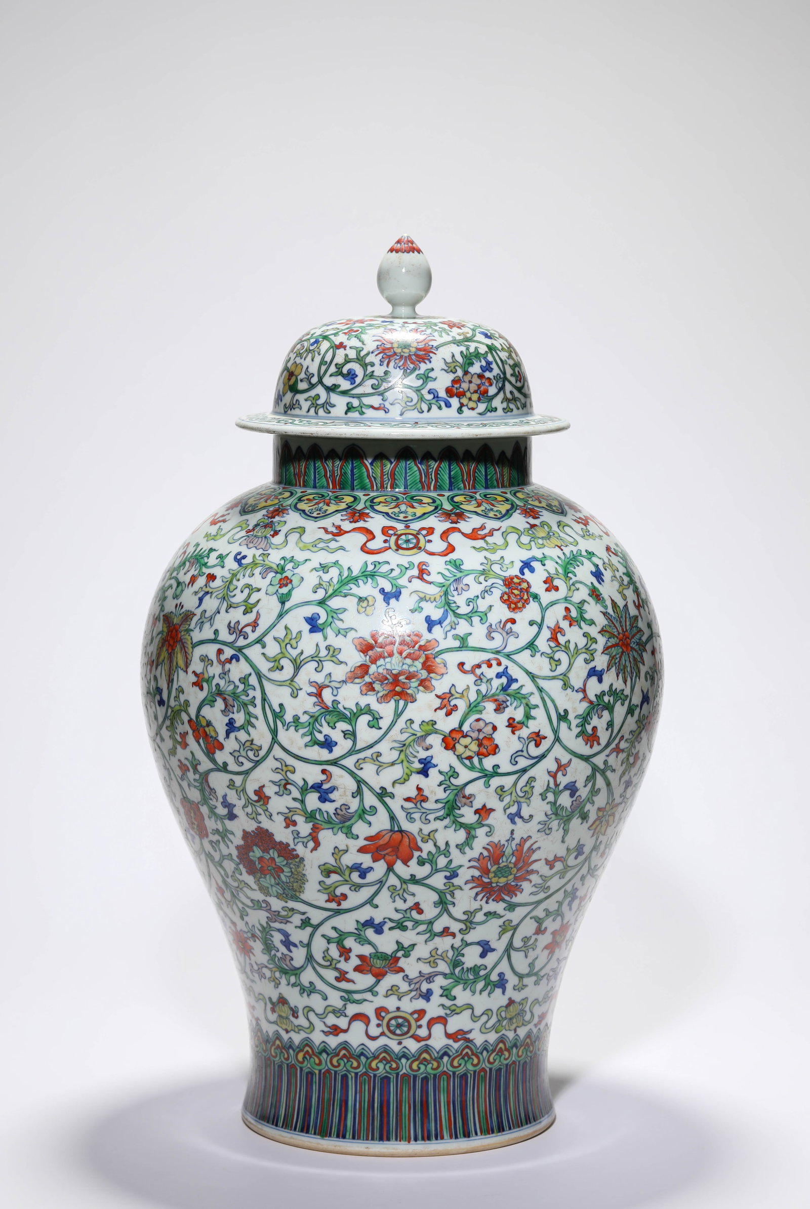 A Doucai 'Interlocking Florals and Eight Buddhist Emblems' 'General's Helmet' Jar and Cover (1 of 4)