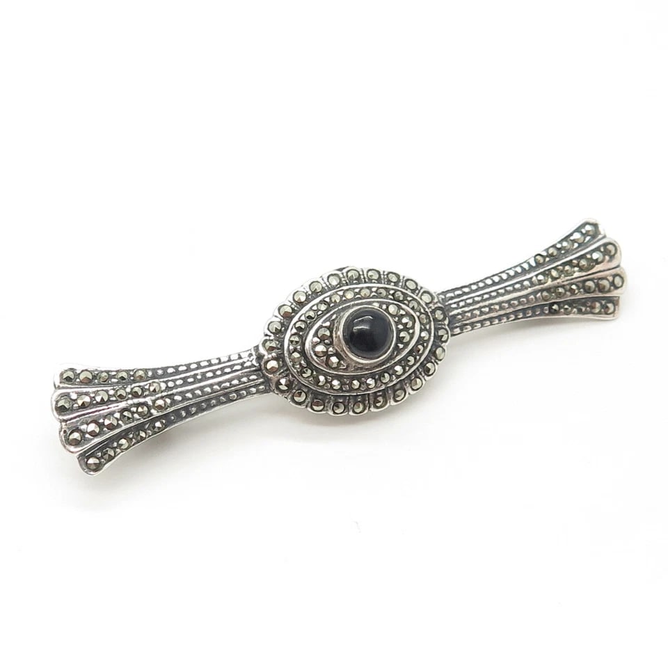 Vintage Silver-Tone Marcasite and Black Cabochon Bar Brooch: VINTAGE SILVER-TONE MARCASITE AND BLACK CABOCHON BAR BROOCH Provenance and Authenticity: This object is presented as a vintage silver-tone bar brooch featuring a central black cabochon surrounded by c