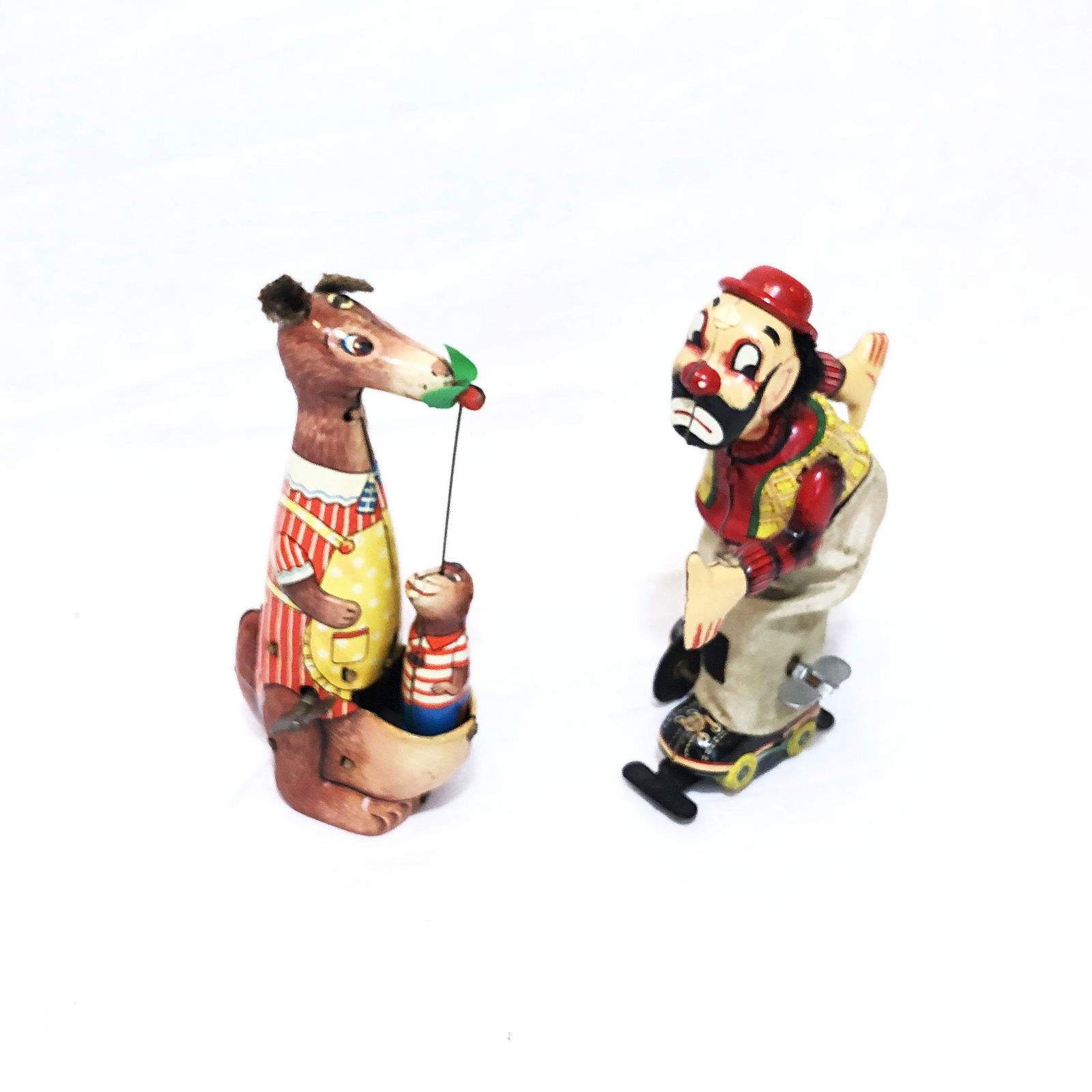 A Set of 2 TPS Tin Toys: A Set of 2 TPS Tin Toys. One TPS clown on roller skates in very good condition and one TPS mama kangaroo with playful baby in very good condition. Condition: Very good.