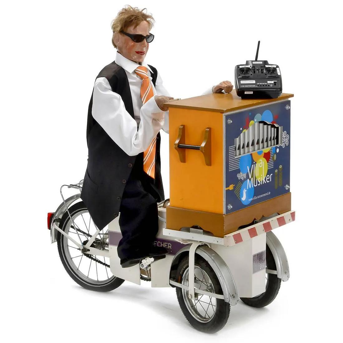 Remote-Controled Automaton Dummy Organ Player on Tricycle: Working remote-controled automaton organ player on tricycle with papier-mÃ¢chÃ© head and hands, dummy barrel organ with built-in tape recorder, on solid tricycle with electric drive. Built-in rech