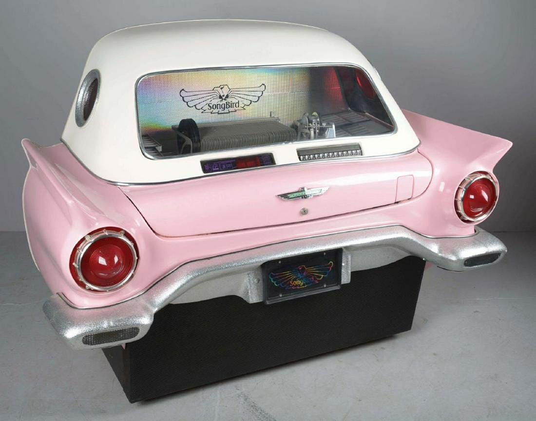 Songbird '57 Thunderbird Jukebox: This rare jukebox has a pink 1957 Ford Thunderbird style fiberglass body with a white top that fits flush against a wall. It currently has 6 of the 80 Slots for 45 rpm vinyl records full and the same